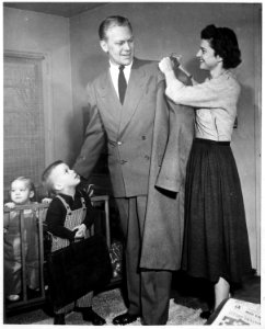 Photograph of Betty Ford Helping Representative Gerald R. Ford with his Overcoat, as Sons Michael Ford and John... - NARA - 186878