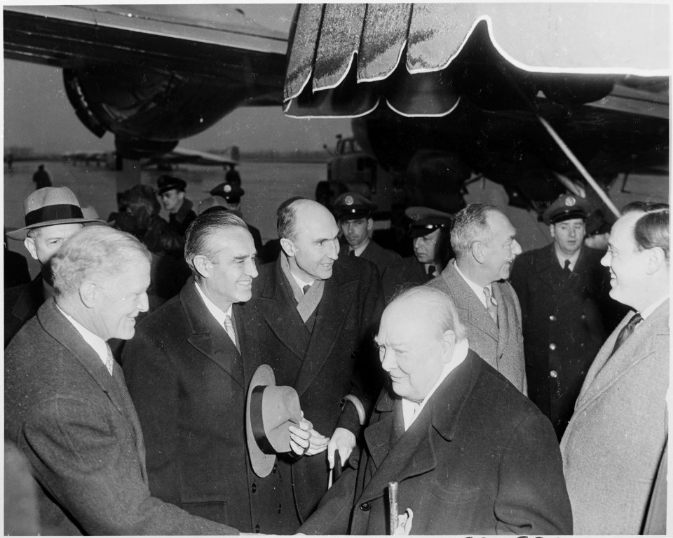 Photograph of British Prime Minister Winston Churchill arriving at the airport in Washington and being greeted by a... - NARA - 200412