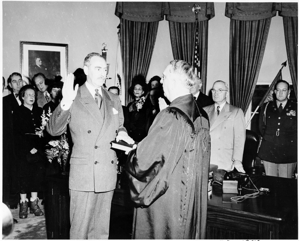Photograph of Dean Acheson taking the oath of office as Secretary of State in the Oval Office, with Chief Justice... - NARA - 200076