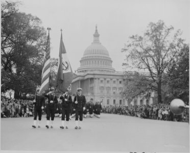 Photograph of color guard and troops marching by the U.S. Capitol during ceremonies honoring Admiral Chester Nimitz. - NARA - 199206