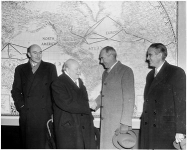 Photograph of British Prime Minister Winston Churchill shaking hands with Secretary of State Dean Acheson in front of... - NARA - 200413