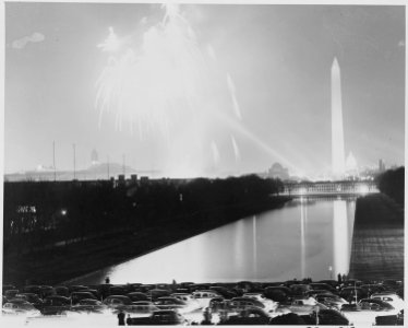 Photograph of fireworks lighting up the night sky overlooking the Washington Monument and the Reflecting Pool, during... - NARA - 200069