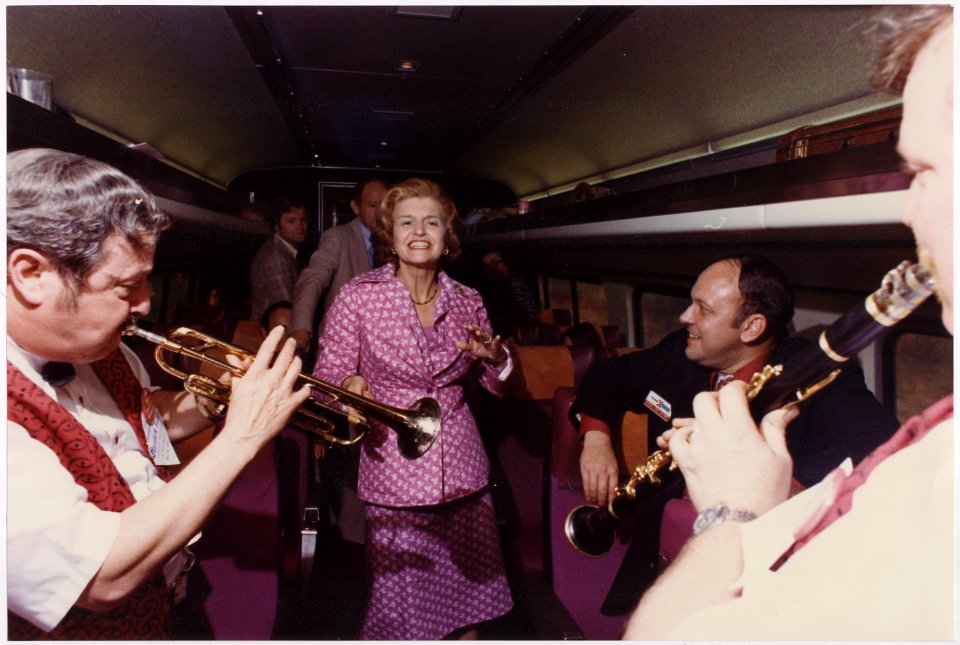 Photograph of First Lady Betty Ford Dancing to the Music of Musicians Traveling with the Presidential Party Across... - NARA - 186829