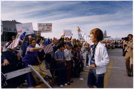 Photograph of First Lady Betty Ford Being Greeted by a Group of Supporters, Many of Which are Carrying Signs, Upon... - NARA - 186826