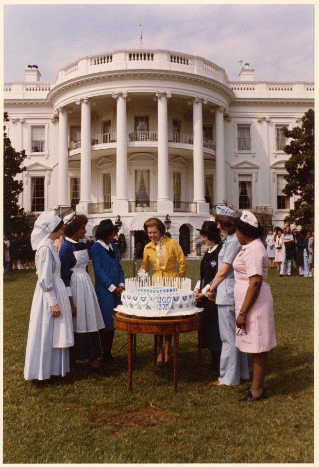 Photograph of First Lady Betty Ford Helping to Cut a Cake Marking the 75th Anniversary of the Visiting Nurses... - NARA - 186796
