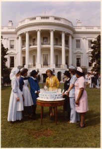 Photograph of First Lady Betty Ford Helping to Cut a Cake Marking the 75th Anniversary of the Visiting Nurses... - NARA - 186796 photo