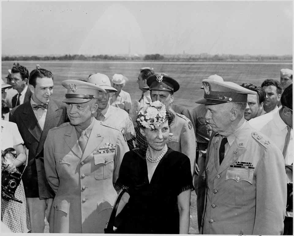 Photograph of General Dwight D. Eisenhower, his wife Mamie, and General George C. Marshall, at the airport in... - NARA - 199127