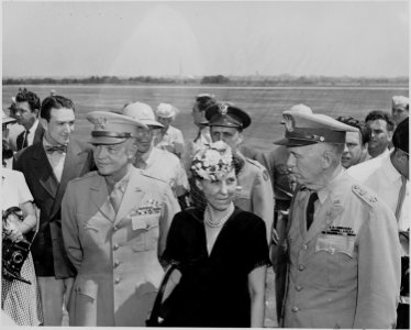 Photograph of General Dwight D. Eisenhower, his wife Mamie, and General George C. Marshall, at the airport in... - NARA - 199127