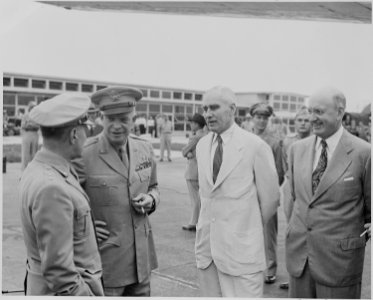 Photograph of General Dwight D. Eisenhower with a group of unidentified persons, probably at the airport in Washington. - NARA - 199123