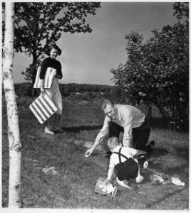 Photograph of Betty Ford Watching Representative Gerald R. Ford Play with Their Son Michael Outside Their Apartment... - NARA - 186873