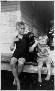 Photograph of Gerald R. Ford, Jr., Sitting on Front Porch with Half-Brother Thomas Tom Ford and a Puppy - NARA - 186939 photo