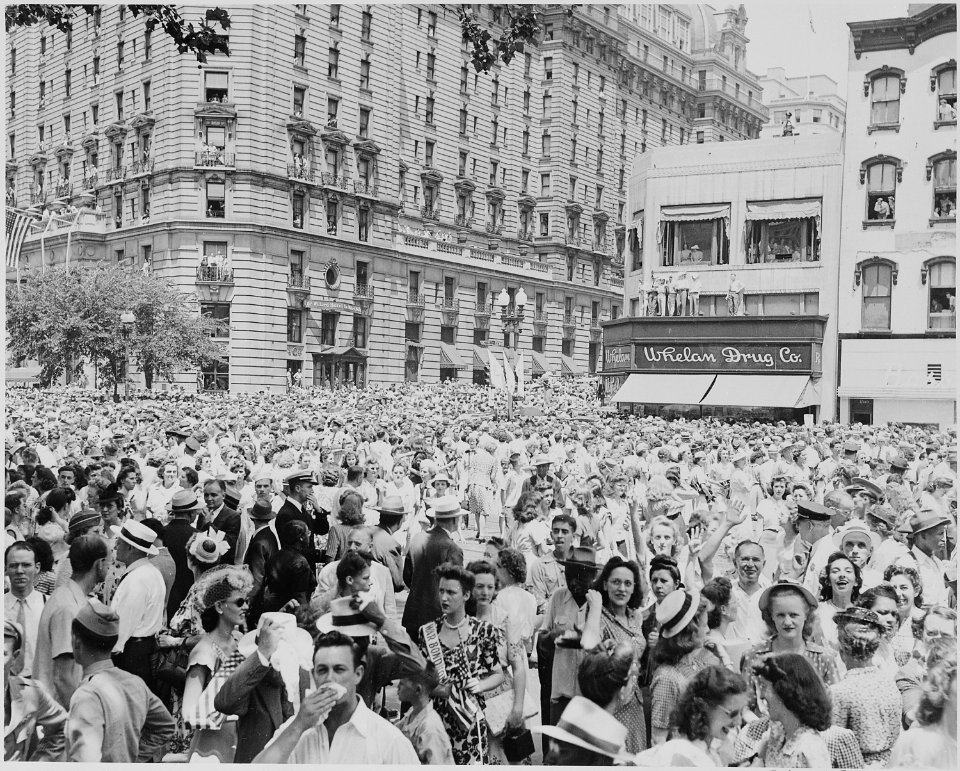 Photograph of large crowd gathered along a Washington street to welcome General Dwight D. Eisenhower. - NARA - 199116