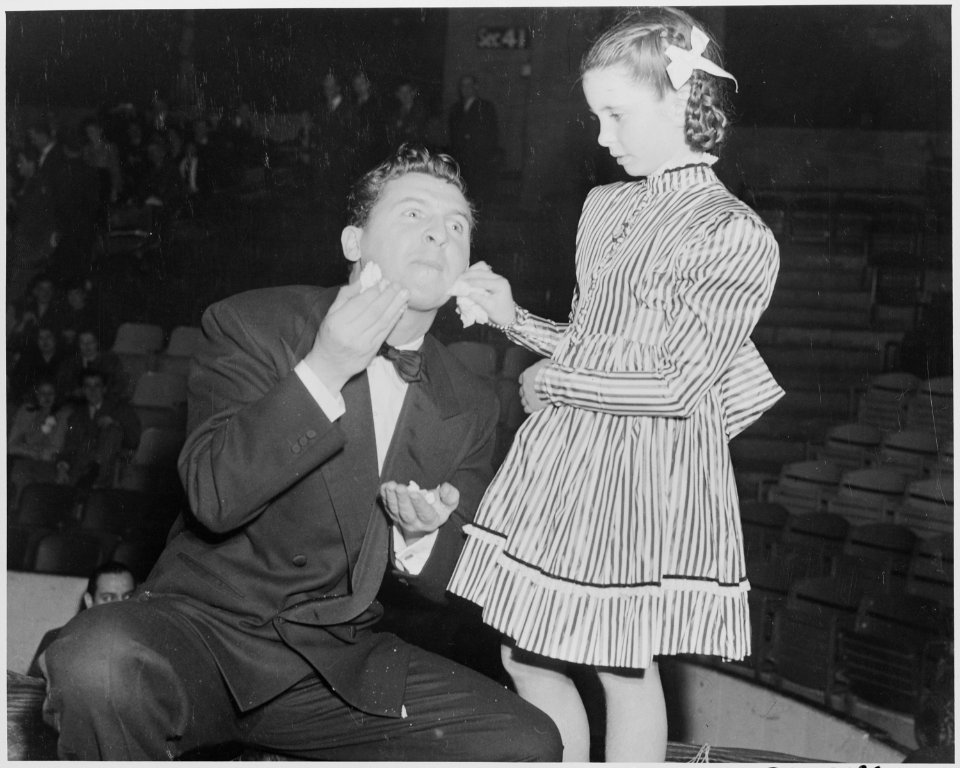 Photograph of Margaret O'Brien posing with fellow Hollywood celebrity Eddie Bracken at a Roosevelt Birthday Ball... - NARA - 199335