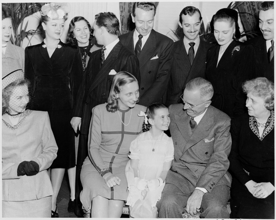 Photograph of Margaret O'Brien sitting between President Truman and Margaret Truman, as Bess Truman and assorted... - NARA - 199332