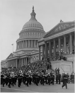 Photograph of military band marching past the U.S. Capitol during ceremonies honoring Admiral Chester Nimitz. - NARA - 199204