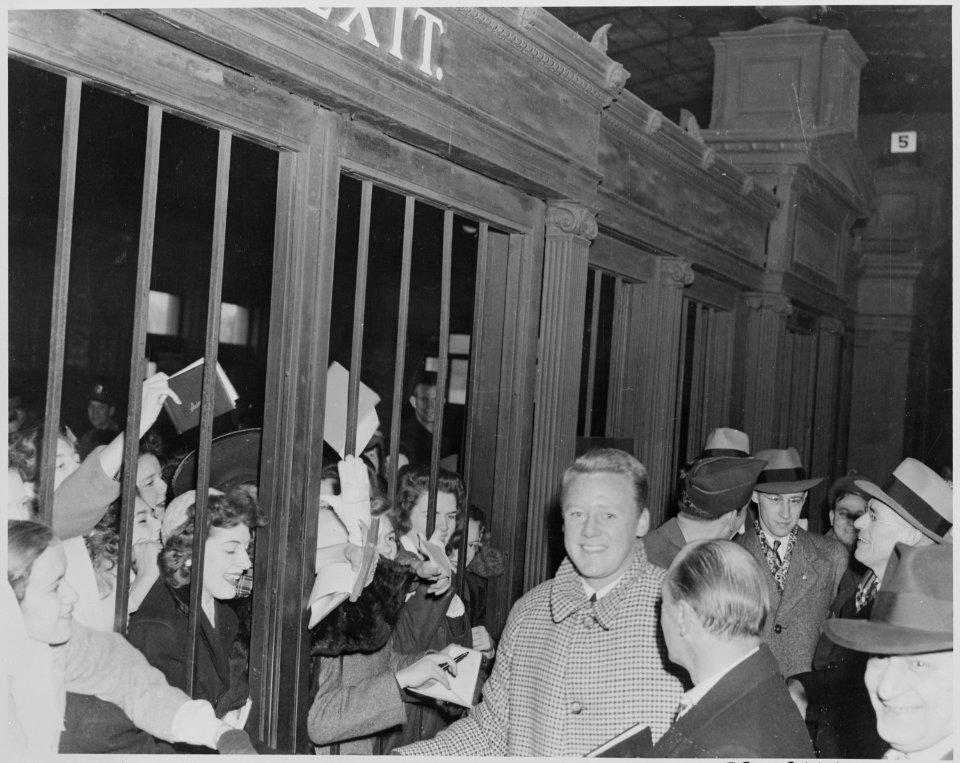 Photograph of movie star Van Johnson being besieged by autograph seekers upon his arrival in Washington to... - NARA - 199316