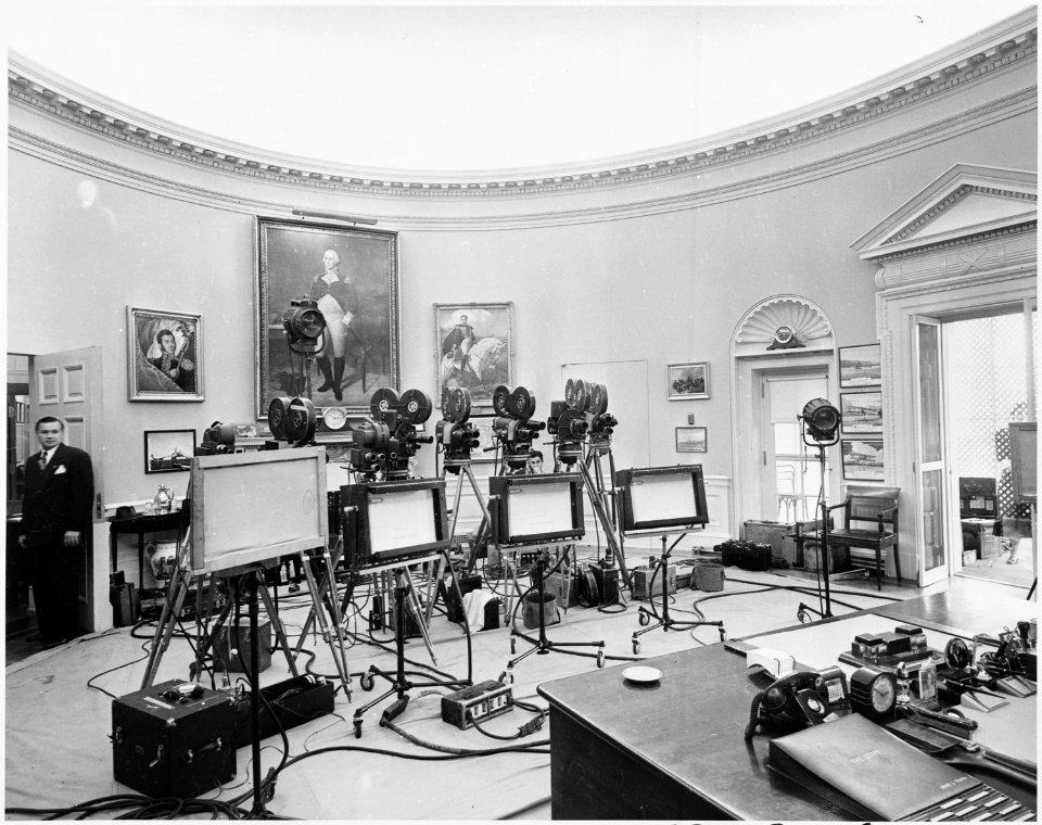 Photograph of newsreel cameras, teleprompters, and other equipment set up in the Oval Office for President Truman's... - NARA - 200354