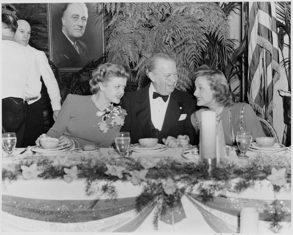 Photograph of movie stars Angela Lansbury, Charles Coburn, and Constance Moore, seated at a table during a Roosevelt... - NARA - 199325