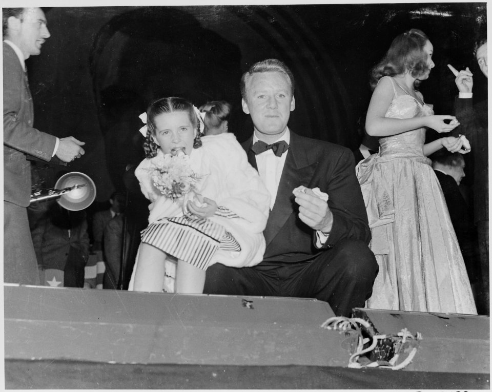 Photograph of movie star Van Johnson with actress Margaret O'Brien, eating cake during a Roosevelt Birthday Ball... - NARA - 199333