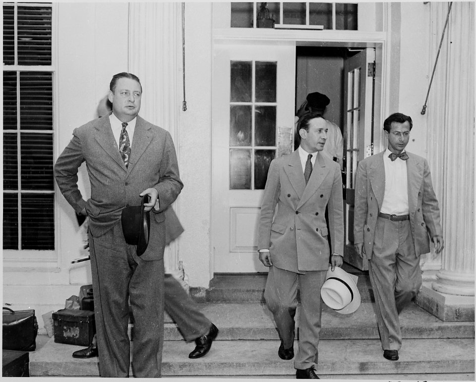 Photograph of officials outside the White House, evidently after Cabinet meeting, (from left to right) Julius Krug of... - NARA - 199140