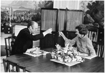 Photograph of President Gerald Ford and First Lady Betty Ford Offering Each Other a Toast in the Second Floor Family... - NARA - 186779 photo