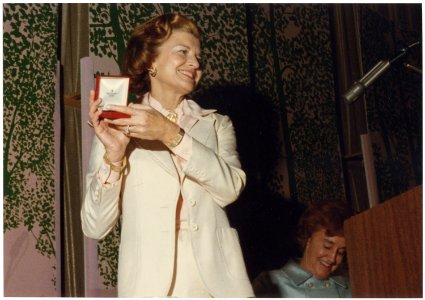 Photograph of Mrs. Betty Ford Displaying the Bracelet She Received During the First Lady's Breakfast, Sponsored by... - NARA - 186809