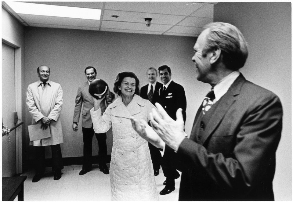 Photograph of President Gerald Ford and First Lady Betty Ford Tossing a Football in the Hallway Near the President's... - NARA - 186775