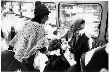 Photograph of President Gerald R. Ford Talking to a Woman Refugee while Holding a Vietnamese Baby on a United States... - NARA - 186795