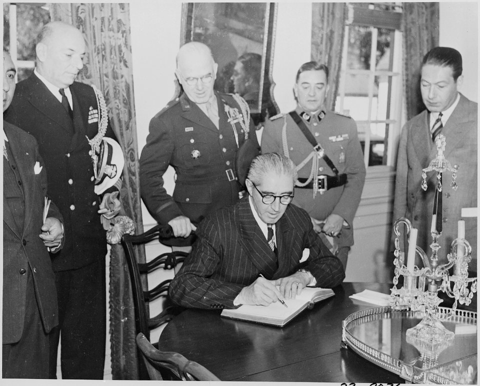 Photograph of President Juan Antonio Rios of Chile signing a visitor's book, probably at Mount Vernon. - NARA - 199230