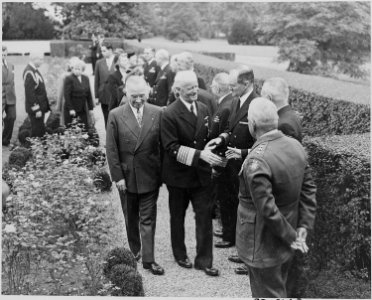 Photograph of President Truman and Admiral Chester Nimitz entering the Rose Garden at the White House. - NARA - 199221