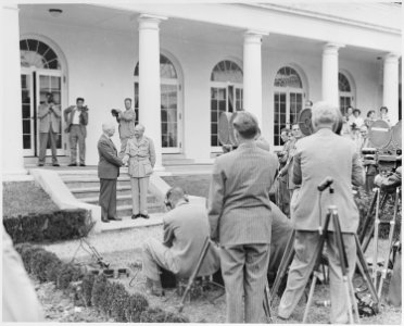 Photograph of President Truman and Field Marshal Montgomery shaking hands outside the White House, surrounded by... - NARA - 199429