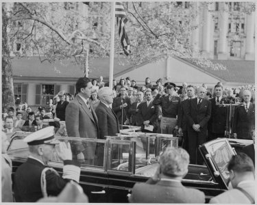 Photograph of President Truman and Mexican President Miguel Aleman standing at attention in the back of an open... - NARA - 199560