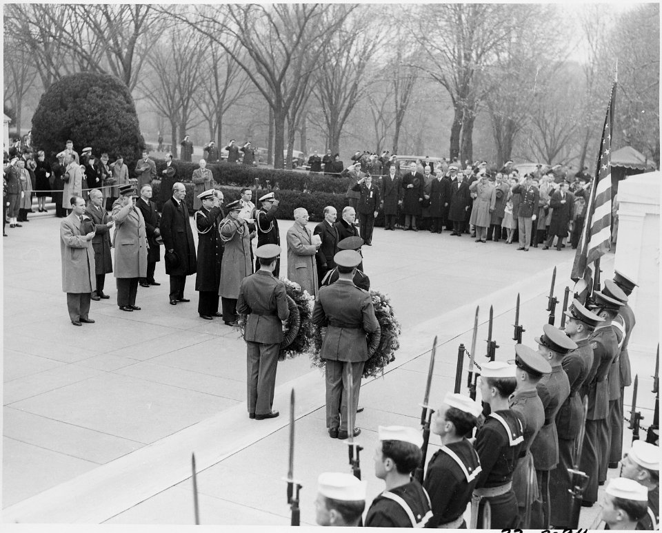 Photograph of President Truman and British Prime Minister Clement Attlee, with others, standing at attention before... - NARA - 199249