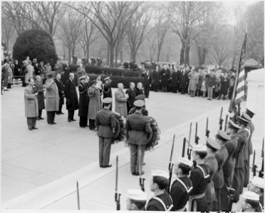 Photograph of President Truman and British Prime Minister Clement Attlee, with others, standing at attention before... - NARA - 199249