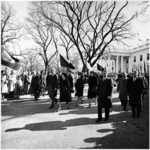 Photograph of President Lyndon B. Johnson and his family walking from the White House as part of the funeral... - NARA - 200453