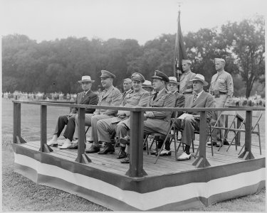 Photograph of President Truman and other dignitaries seated on the reviewing stand, watching the District of Columbia... - NARA - 199386