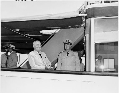 Photograph of President Truman and a naval officer, apparently aboard the presidential yacht, the U.S.S.... - NARA - 200218 photo