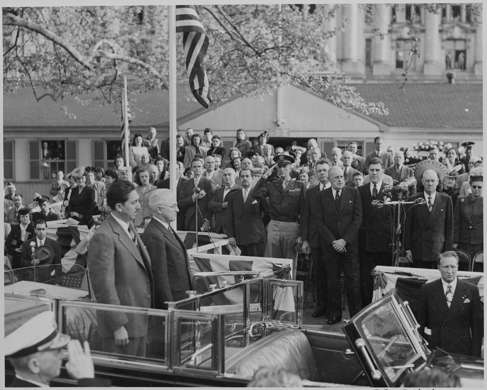 Photograph of President Truman and Mexican President Miguel Aleman standing at attention in the back of an open... - NARA - 199561