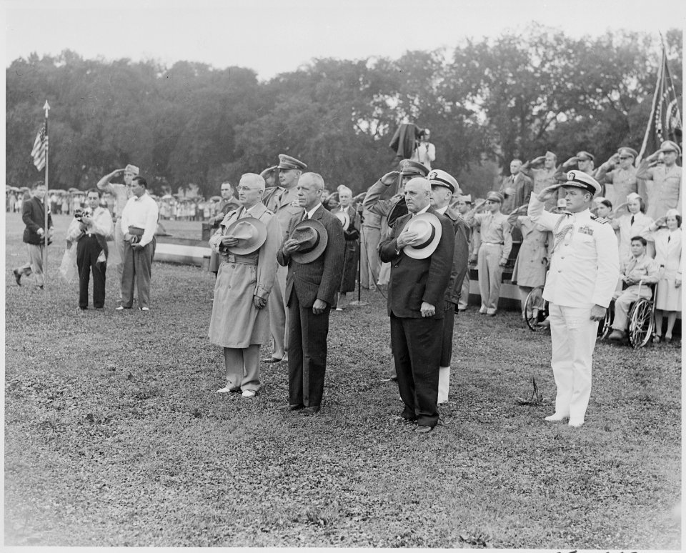 Photograph of President Truman and other dignitaries saluting during the President's review of the 442nd Regimental... - NARA - 199387