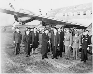 Photograph of President Truman and the Shah of Iran shaking hands at Washington National Airport upon the Shah's... - NARA - 200142 photo