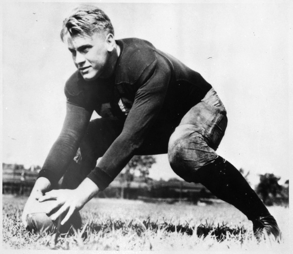 Photograph of Gerald R. Ford, Jr., Centering a Football During Practice at the University of Michigan, Ann Arbor... - NARA - 186892