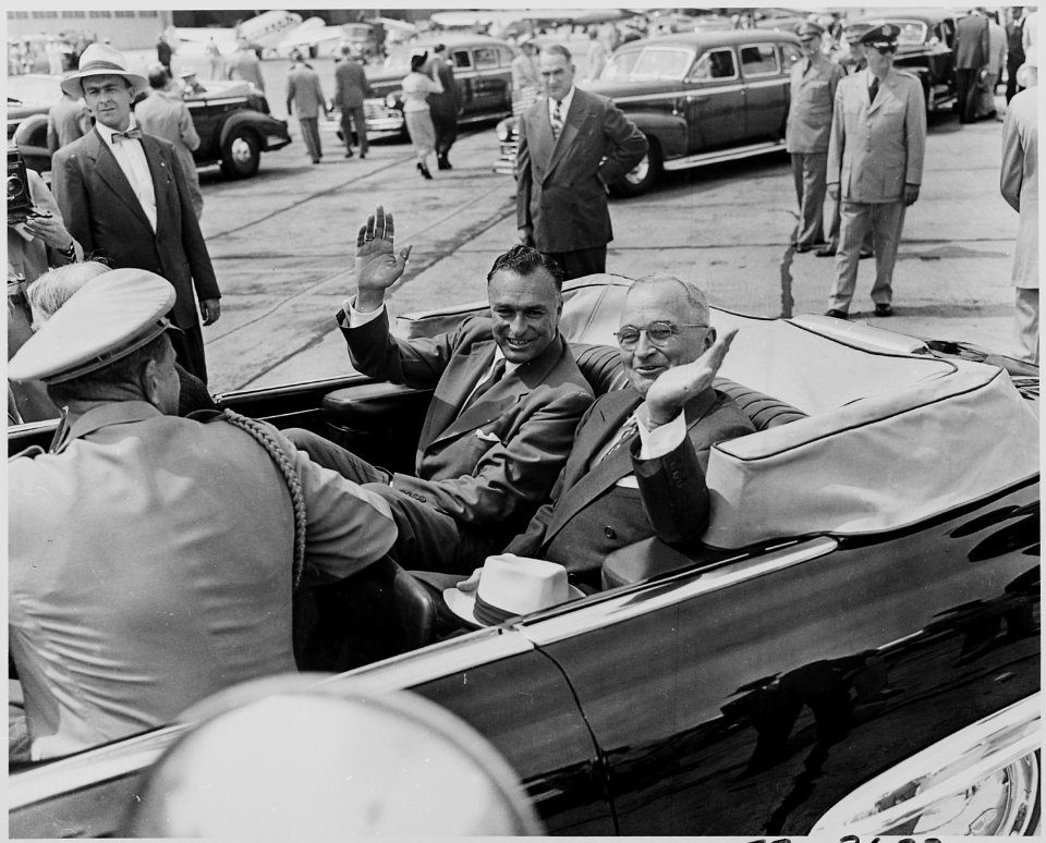 Photograph of President Truman and President Galo Plaza of Ecuador waving from the back of their limousine, during... - NARA - 200301
