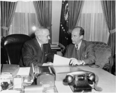 Photograph of President Truman at his desk in the Oval Office with Governor Adlai E. Stevenson of Illinois, the... - NARA - 200405
