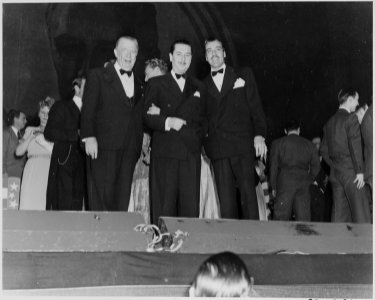 Photograph of movie stars Charles Coburn, Reginald Gardiner, and Cesar Romero, at a Roosevelt Birthday Ball event in... - NARA - 199341