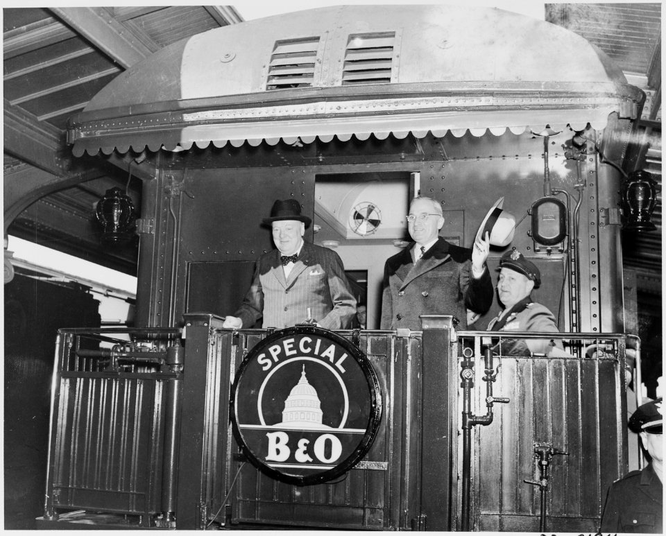 Photograph of President Truman and Prime Minister Churchill standing on the rear platform of a special Baltimore... - NARA - 199349