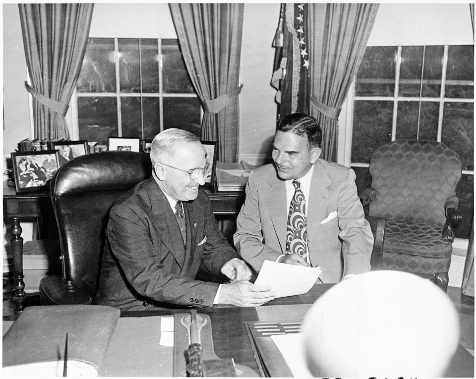 Photograph of President Truman conferring in the Oval Office with the man he defeated in the 1948 presidential... - NARA - 200323