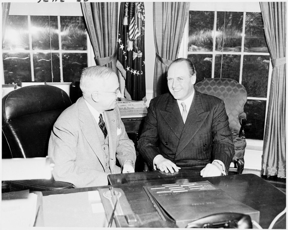 Photograph of President Truman at his desk in the Oval Office with Crown Prince Olav of Norway. - NARA - 200247