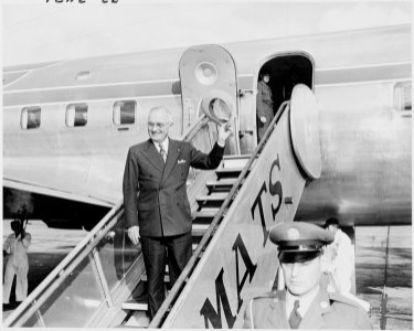 Photograph of President Truman at Washington National Airport, waving farewell as he prepares to board his airplane... - NARA - 200245 photo