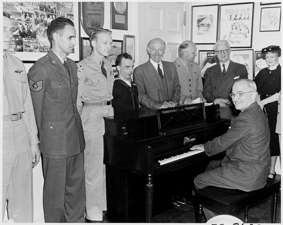 Photograph of President Truman in the Fish Room of the White House, playing a piano given to him by the Piano... - NARA - 200297