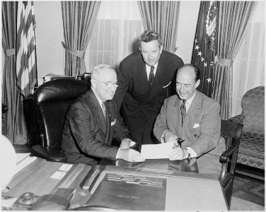 Photograph of President Truman in the Oval Office conferring with Governor Adlai E. Stevenson of Illinois, the... - NARA - 200392